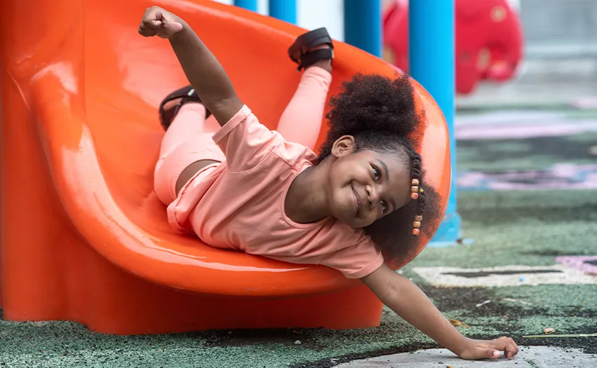 A child sliding down a slide (Photo)