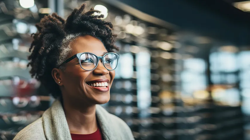 A portrait of a woman with glasses smiling (Photo)